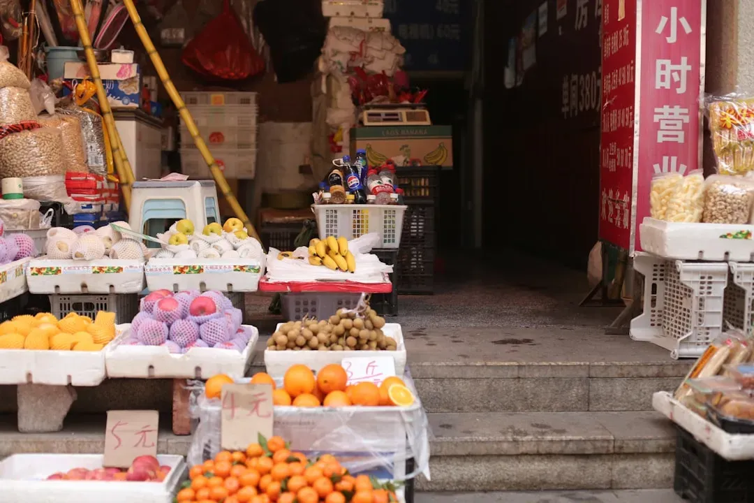 Farmers market stand selling fresh aquaponics-grown produce with price signs, demonstrating profitable returns from aquaponic